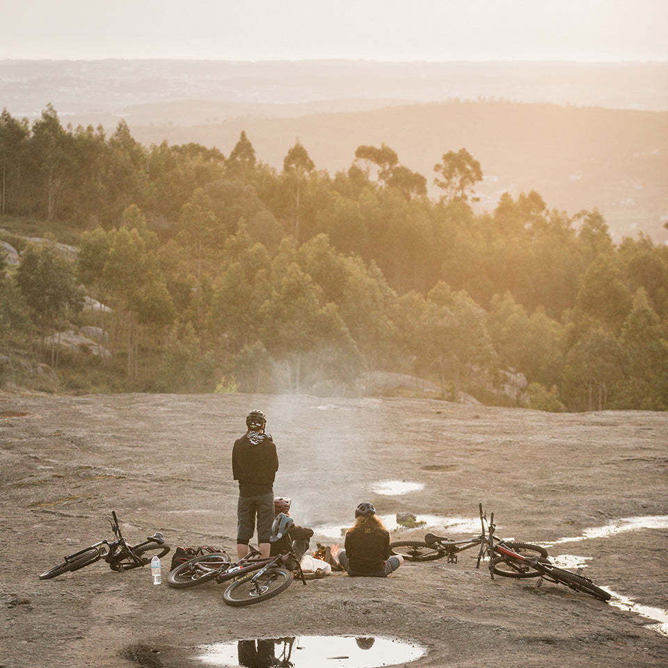 Mountainbikers relaxing beside their bikes after a ride